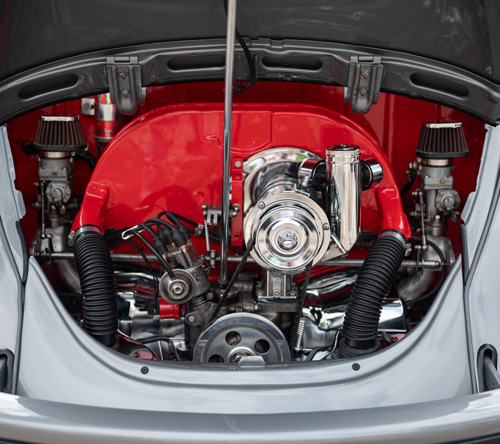 classic car engine with red and chrome details showcasing performance upgrades and automotive craftsmanship